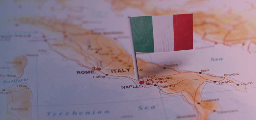 Close-up of an Italian flag pin on a map of Italy, highlighting Naples and Rome, representing the Italian iGaming market and ADM regulations.