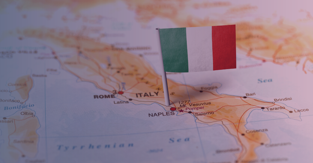 Close-up of an Italian flag pin on a map of Italy, highlighting Naples and Rome, representing the Italian iGaming market and ADM regulations.